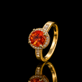 Anel Aperol dourado com pedra redonda laranja e aro com zircônias