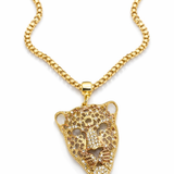 Colar dourado com corrente e pingente de onça com pedrinhas e detalhes vazados