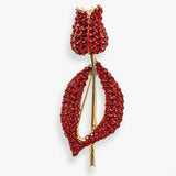 Broche em formato de flor vermelha, com strass e base dourada