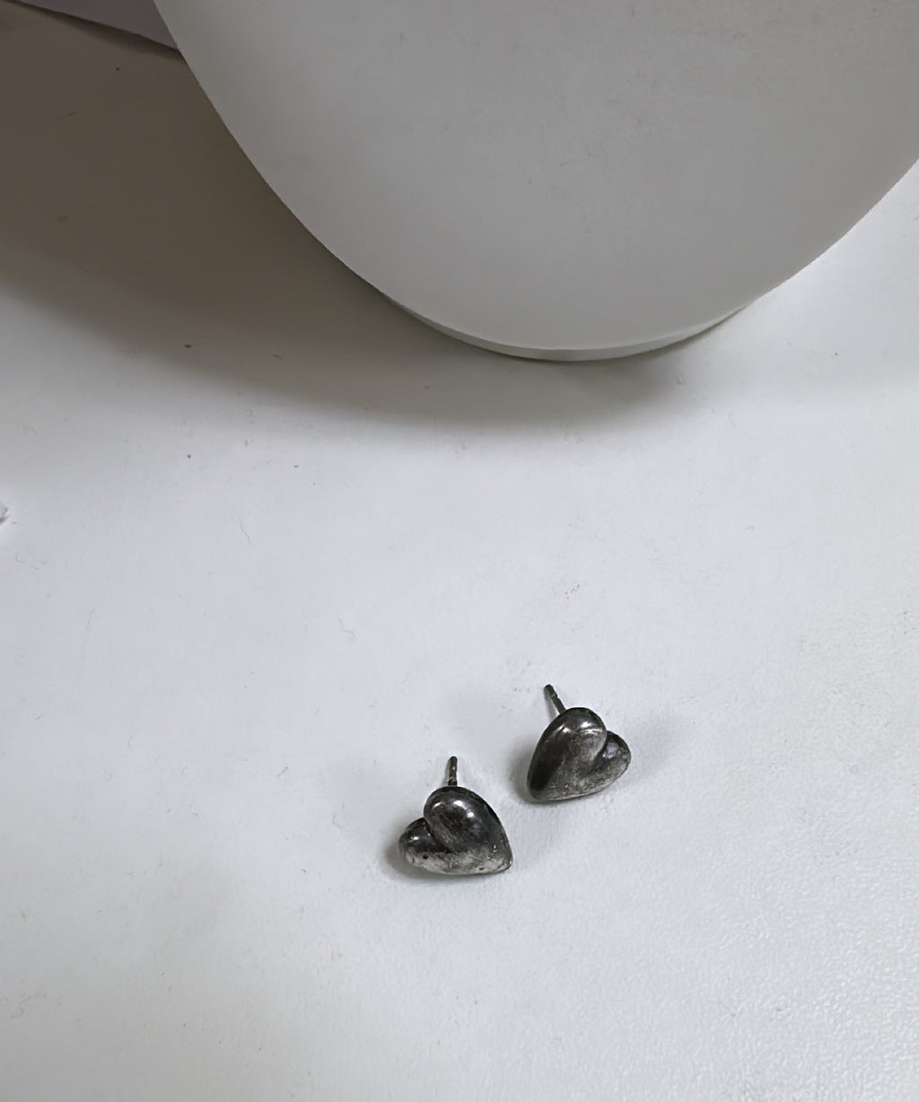 Brinco Lovinho em metal prateado, formato de gota