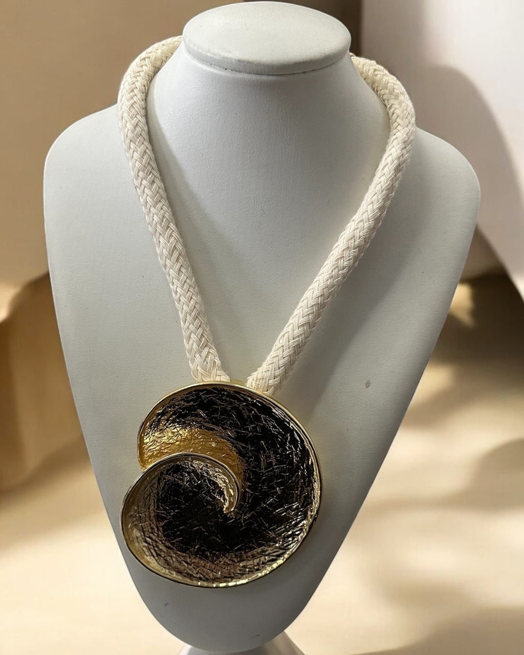 Colar Ocara com cordão trançado branco e pingente circular dourado com textura escura