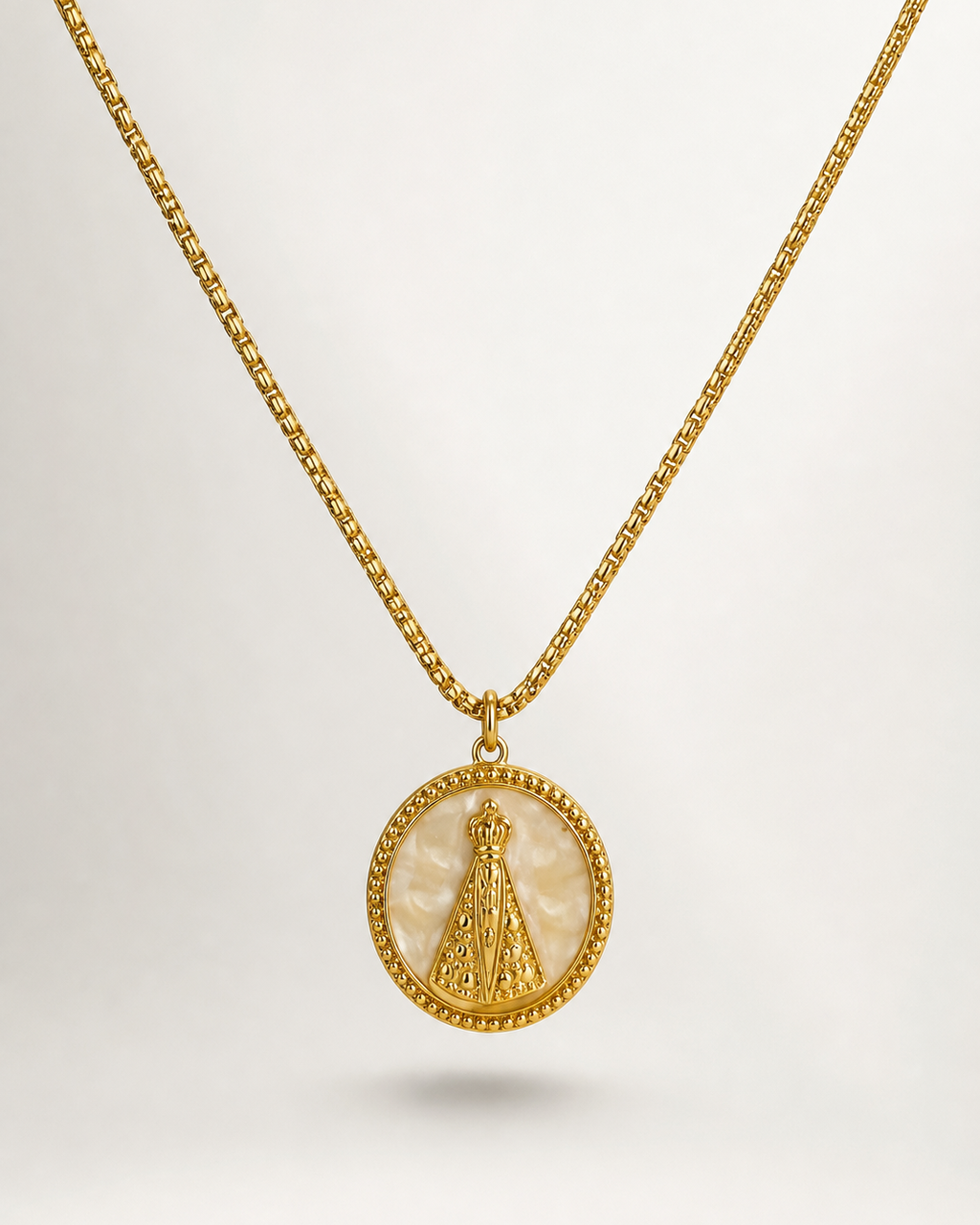 Colar dourado Maria Madre mini com corrente fina e pingente redondo trabalhado