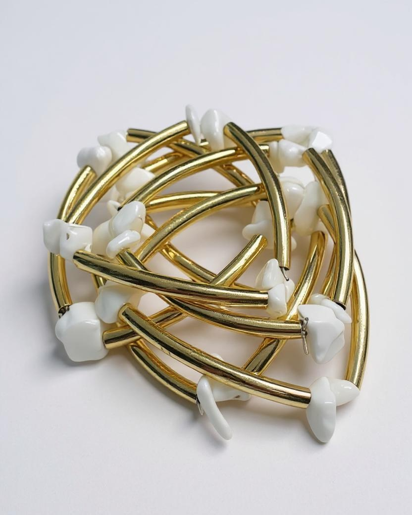 Pulseira folheada dourada com pedras brancas em formato de gota e elos curvos
