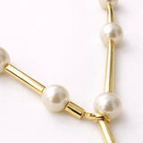 Colar dourado com pérolas e elos em barras