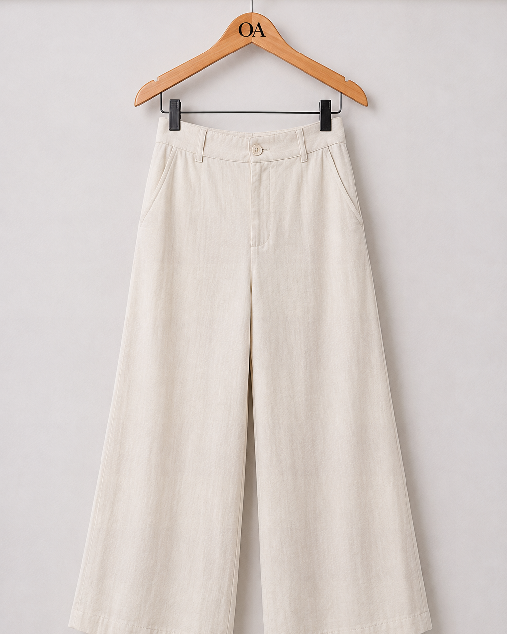 Calça pantalona creme clara, cintura com passantes e pregas, botão frontal