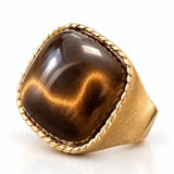Anel dourado com pedra oval olho de tigre e aro trançado