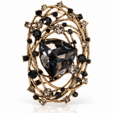 Broche Catarina dourado com pedras pretas e cristal oval central
