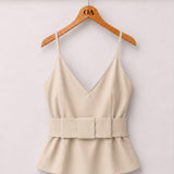 Blusa creme com decote V e alças finas, faixa na cintura e babado