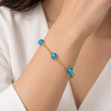 Pulseira dourada com contas redondas turquesa
