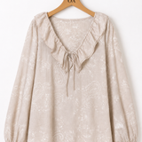 Blusa bege com punhos elásticos e estampa de arabescos delicados