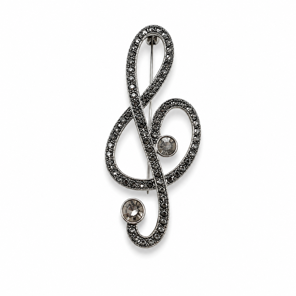 Broche em formato de clave de sol com detalhes de pedras brilhantes e pino