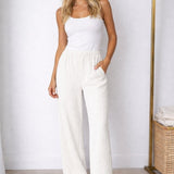 Calça pantalona creme de cintura elástica com modelagem ampla