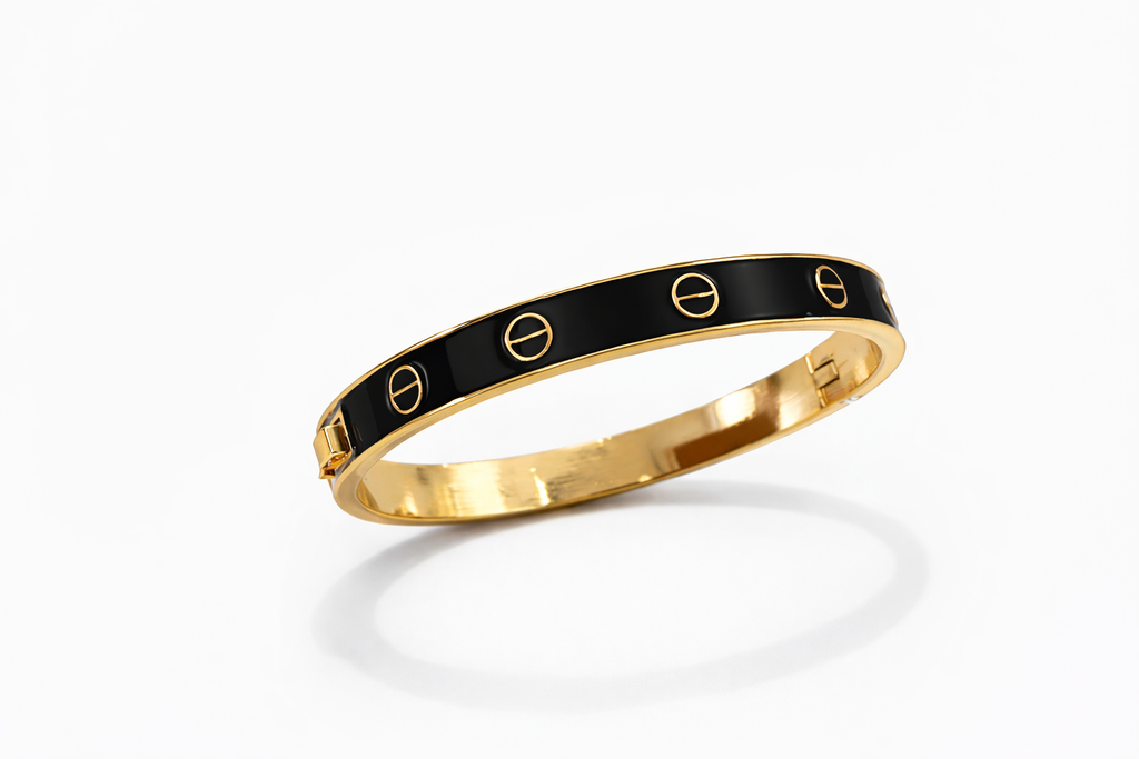 Pulseira Carti em metal dourado com base preta e detalhes circulares vazados